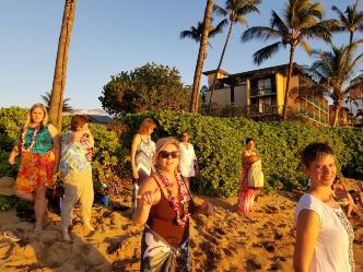 Dance traditional hula on beach with a flower release at sunset!