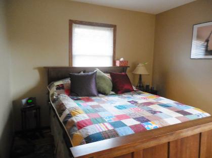 Bedroom before Feng Shui with window behind bed. 